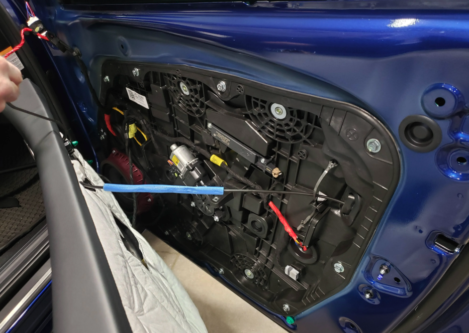 The Kia Sportage window regulator is part of the door vapour barrier and sits on the inside of the door.